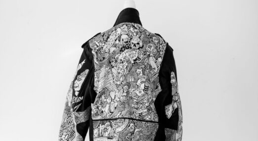 The back of a detailed jacket, covered in drawings